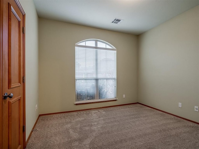 empty room with light colored carpet