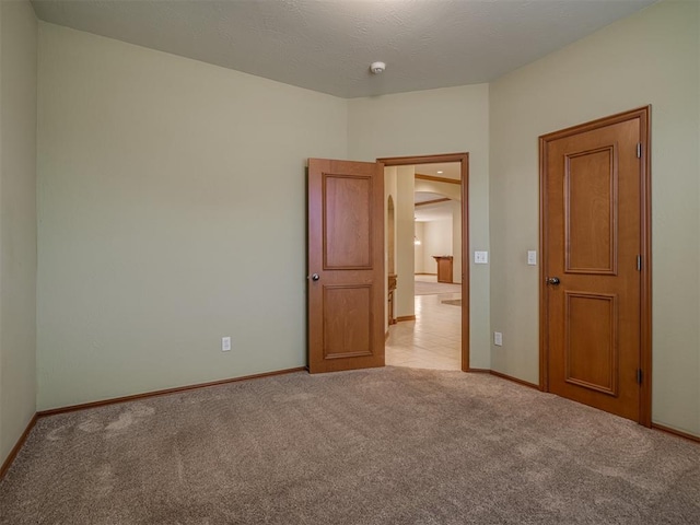 empty room featuring light carpet