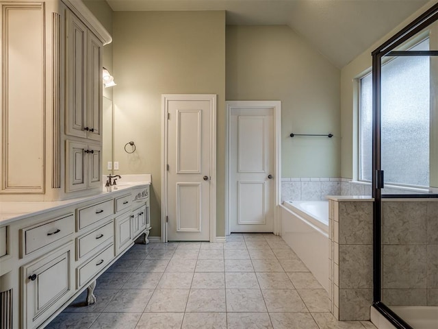 bathroom featuring tile patterned flooring, vanity, lofted ceiling, and plus walk in shower