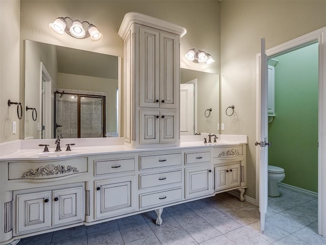 bathroom featuring tile patterned flooring, vanity, toilet, and walk in shower