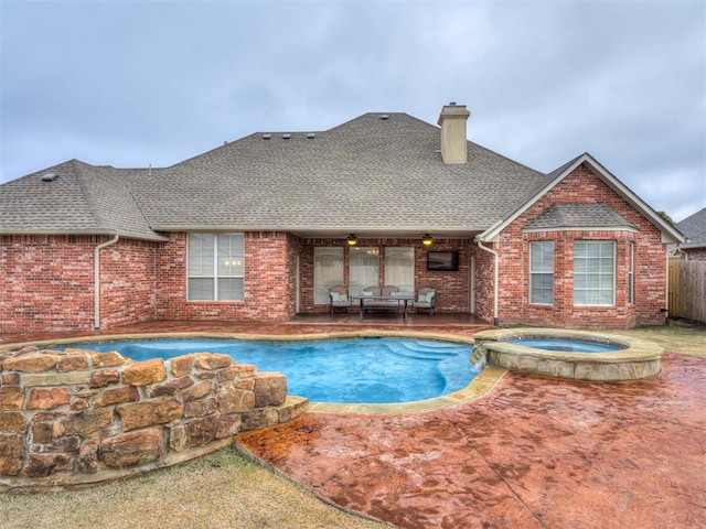 view of swimming pool with a patio area, an in ground hot tub, and ceiling fan