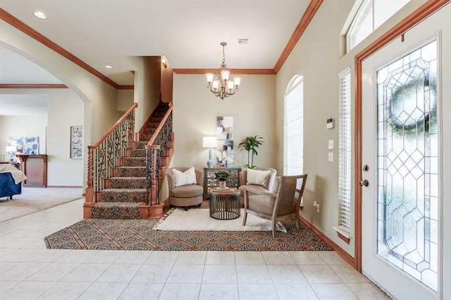 entryway featuring stairway, ornamental molding, tile patterned flooring, and a notable chandelier