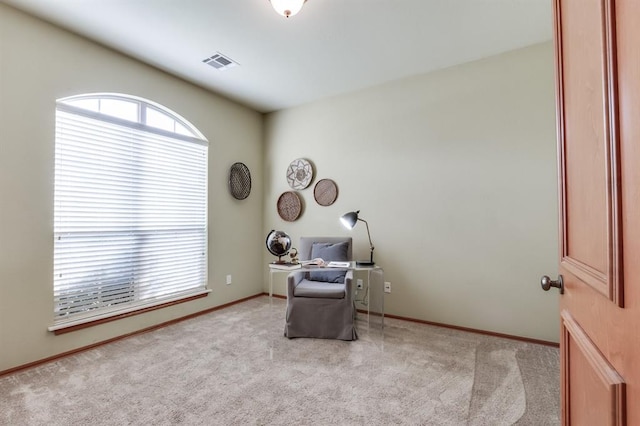 living area featuring carpet floors, baseboards, and visible vents