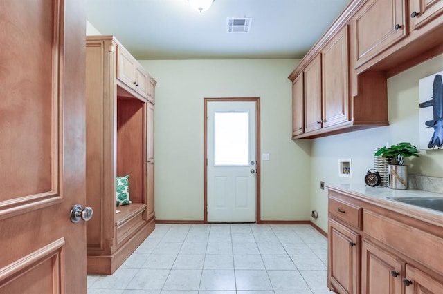 laundry area with light tile patterned floors, visible vents, cabinet space, electric dryer hookup, and washer hookup