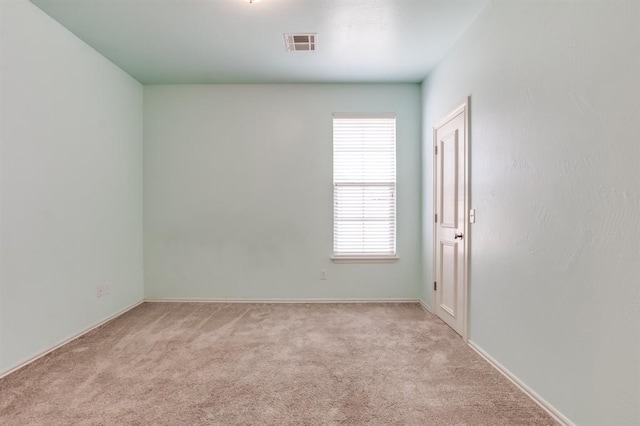 unfurnished room with carpet flooring and visible vents