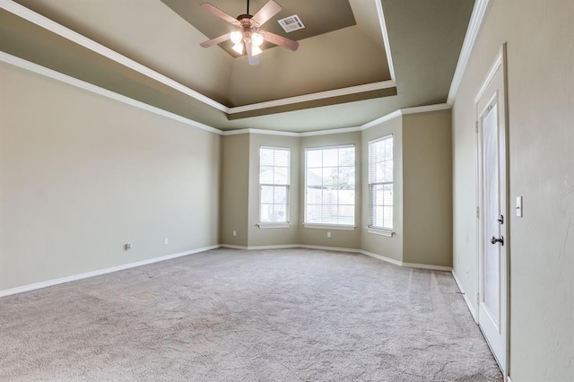 unfurnished room with visible vents, ornamental molding, carpet flooring, and a ceiling fan