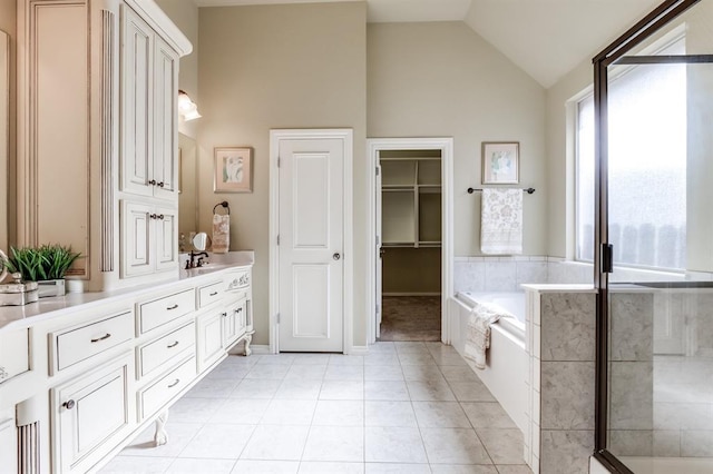 bathroom with tile patterned flooring, vanity, lofted ceiling, tiled shower, and a bath