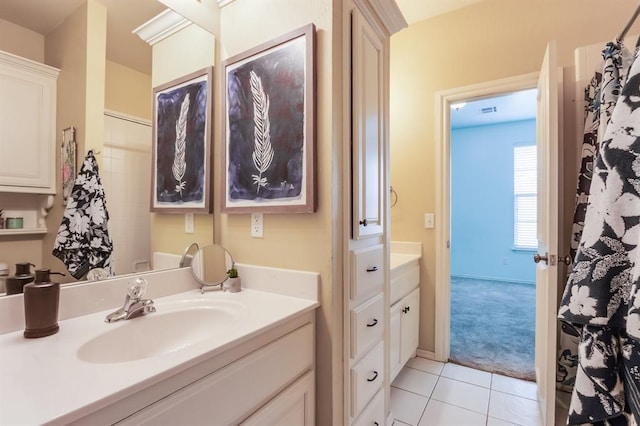 full bathroom featuring tile patterned flooring, vanity, and baseboards