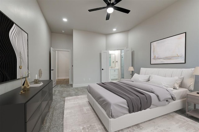 carpeted bedroom with ceiling fan and connected bathroom