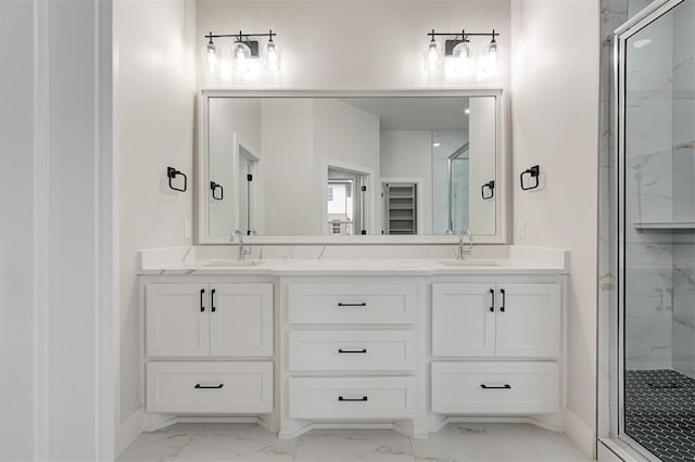 bathroom with vanity and a shower with door