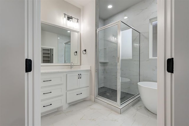 bathroom with vanity and independent shower and bath