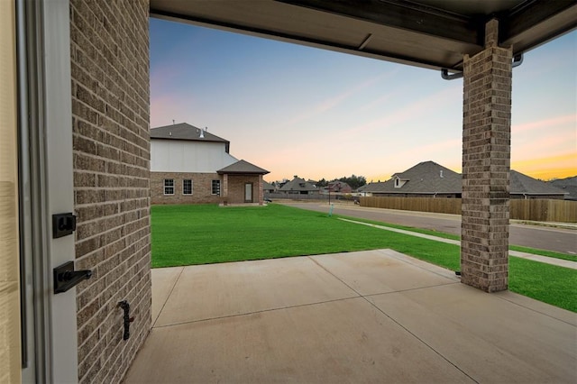 patio terrace at dusk with a yard