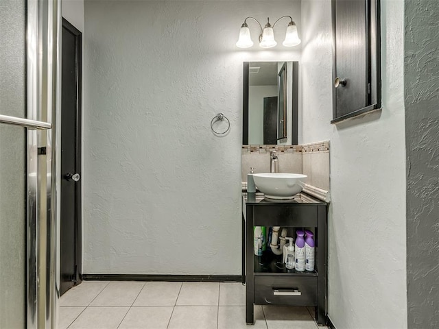 bathroom with vanity, tile patterned flooring, and decorative backsplash