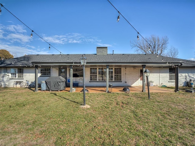 rear view of property with a patio area and a yard