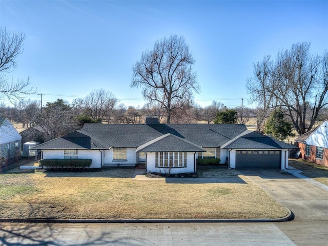 single story home featuring a garage and a front lawn