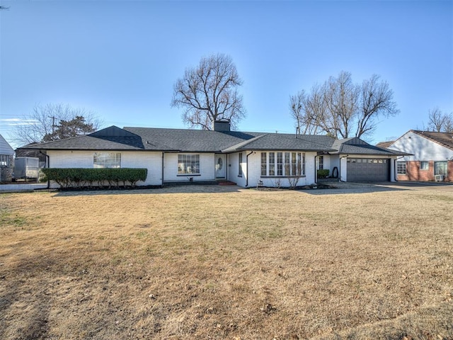 single story home with a garage and a front yard