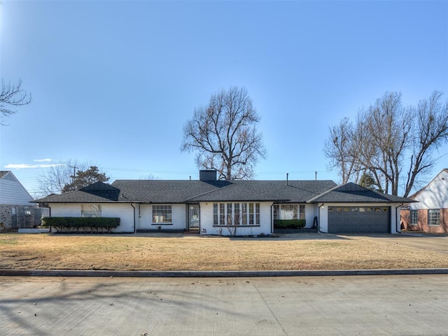 ranch-style house featuring a garage and a front yard