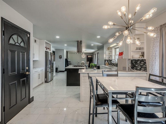 dining area featuring a chandelier and sink