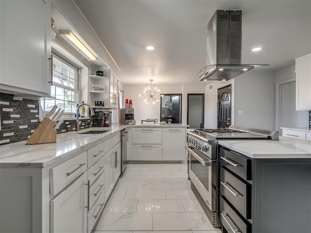 kitchen featuring backsplash, sink, island exhaust hood, stainless steel appliances, and white cabinets