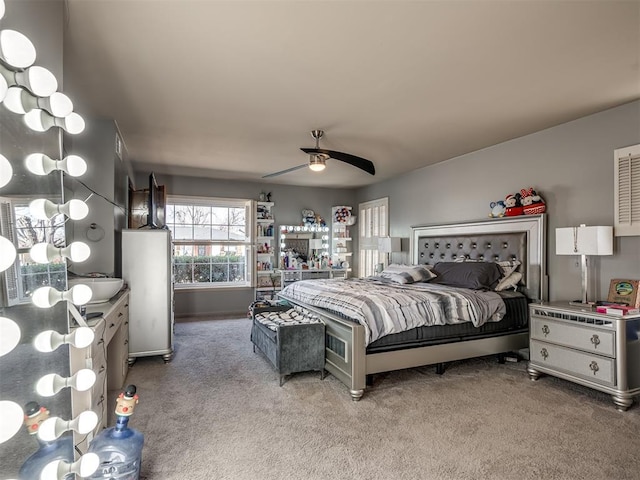 bedroom with ceiling fan and light colored carpet