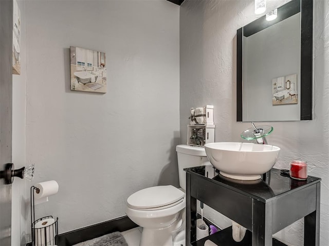 bathroom with toilet and vanity