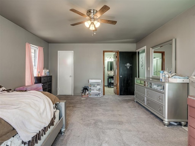 carpeted bedroom with ceiling fan and ensuite bathroom