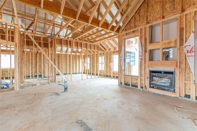 miscellaneous room with a glass covered fireplace