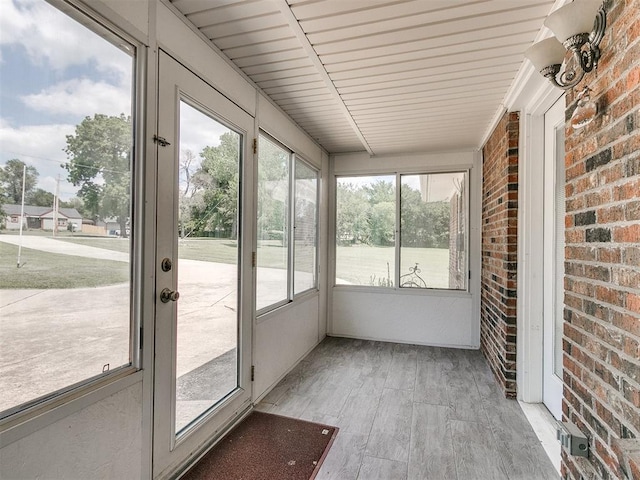 unfurnished sunroom with wooden ceiling