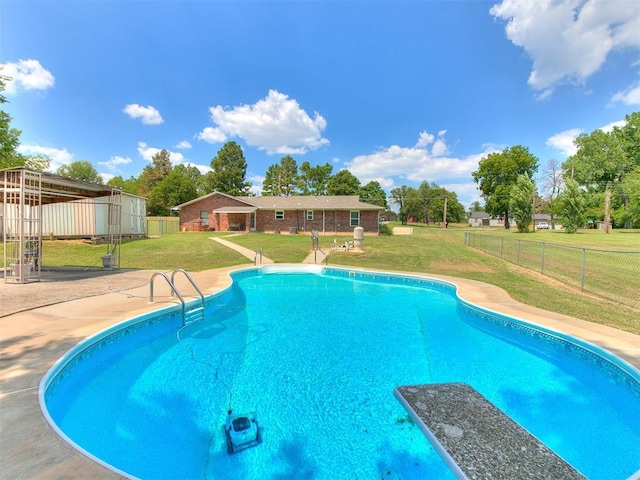 view of swimming pool featuring a lawn and a patio area