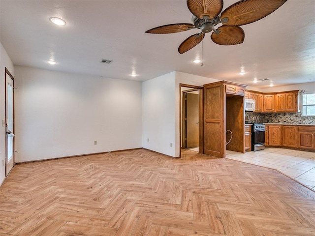 unfurnished living room with ceiling fan and light tile patterned floors