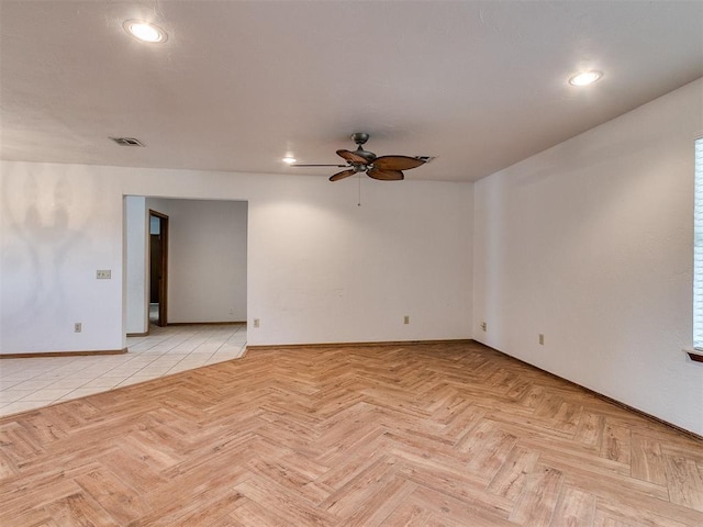 spare room with ceiling fan and light parquet floors