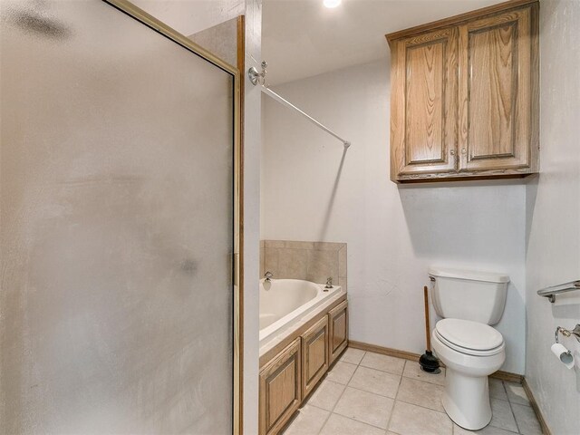 bathroom featuring tile patterned flooring, toilet, and independent shower and bath