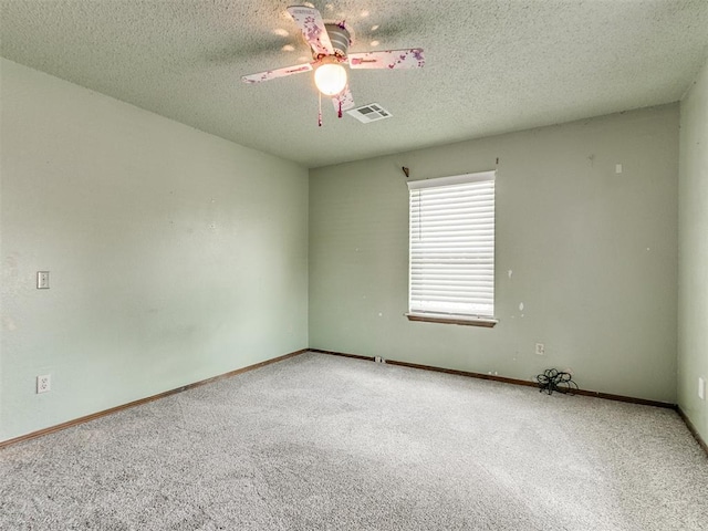 empty room featuring carpet floors and a textured ceiling