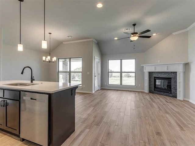 kitchen featuring dishwasher, an island with sink, light wood-type flooring, and sink