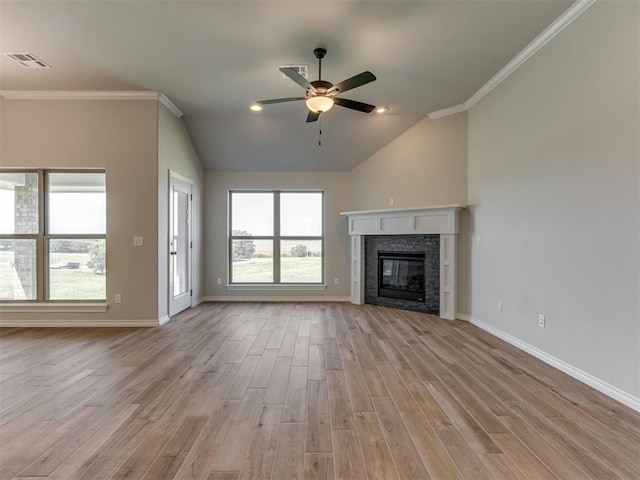 unfurnished living room with light hardwood / wood-style floors, crown molding, and a fireplace