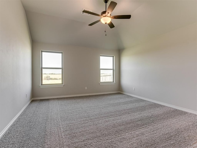 empty room with carpet, ceiling fan, and vaulted ceiling