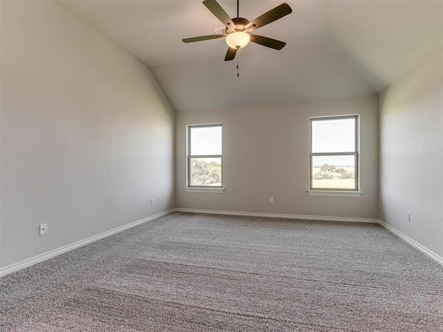 carpeted spare room featuring ceiling fan and lofted ceiling