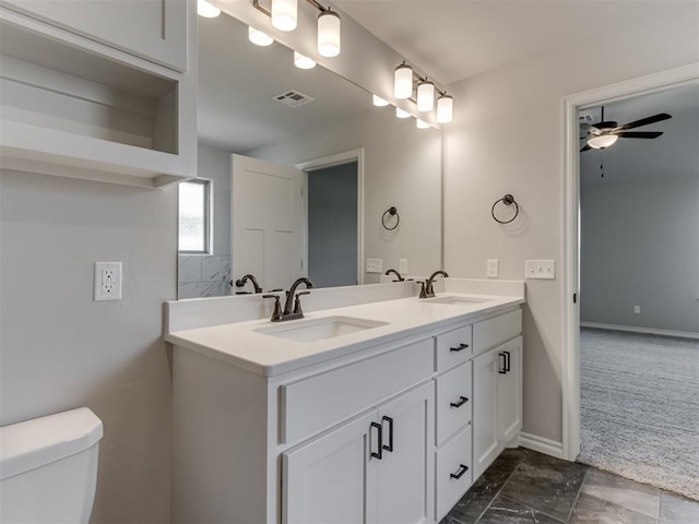 bathroom with ceiling fan, toilet, and vanity