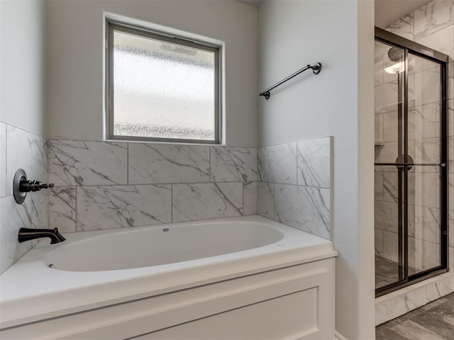 bathroom featuring independent shower and bath