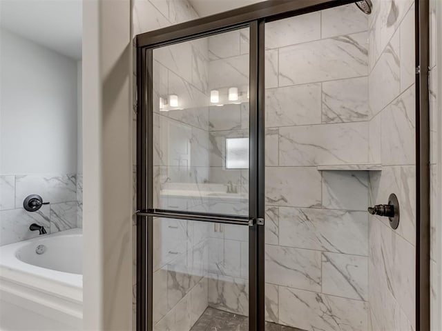 bathroom with separate shower and tub