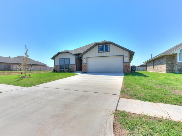 view of front of house featuring a garage and a front lawn