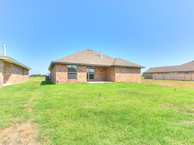 rear view of property featuring a yard