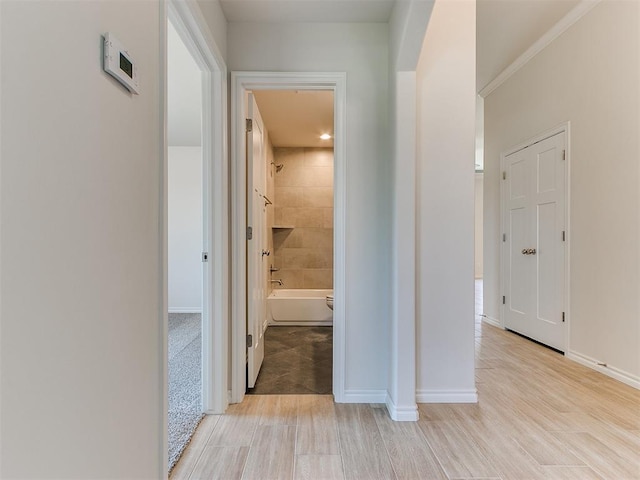 hallway featuring crown molding