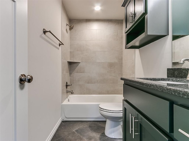 full bathroom featuring tile patterned floors, vanity, toilet, and tiled shower / bath combo