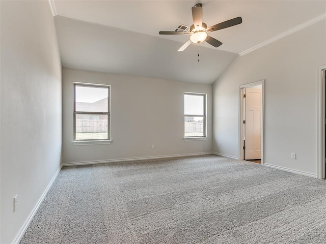 carpeted spare room with ceiling fan and vaulted ceiling