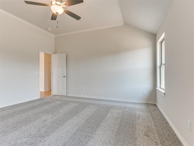 empty room with carpet, ornamental molding, ceiling fan, and lofted ceiling