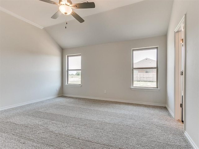 empty room featuring light carpet, ceiling fan, a healthy amount of sunlight, and vaulted ceiling