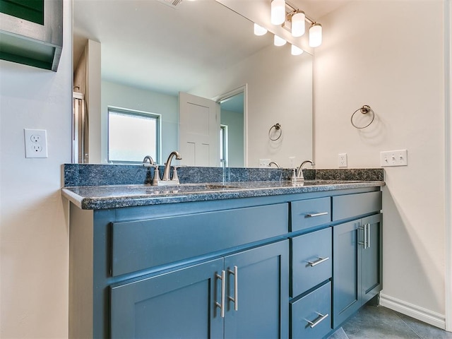 bathroom with tile patterned flooring and vanity