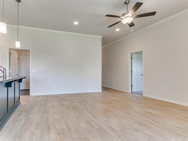 unfurnished living room featuring ceiling fan, light wood-type flooring, and crown molding