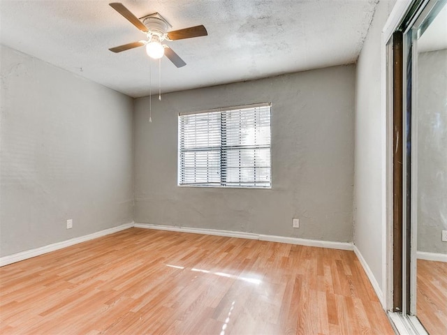 unfurnished room featuring a textured ceiling, light hardwood / wood-style flooring, and ceiling fan